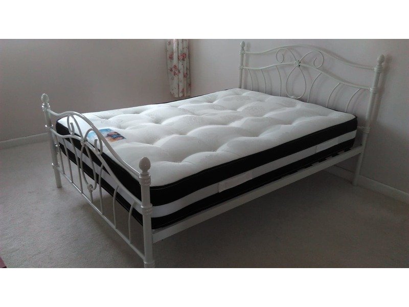 white metal double bed with mattress